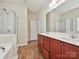 Bathroom featuring double sink vanity and glass enclosed shower at 5355 Hackberry Sw Ln, Concord, NC 28027