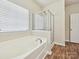 Clean bathroom with a separate bathtub and shower at 5355 Hackberry Sw Ln, Concord, NC 28027