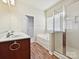 Bathroom with double sink vanity, separate tub and glass-enclosed shower at 5355 Hackberry Sw Ln, Concord, NC 28027