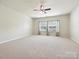 Large bedroom with a ceiling fan and neutral carpet at 5355 Hackberry Sw Ln, Concord, NC 28027