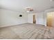 Spacious bedroom featuring a ceiling fan, mounted TV, and access to an ensuite bathroom at 5355 Hackberry Sw Ln, Concord, NC 28027