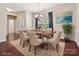 Staged dining room featuring hardwood floors, modern chandelier, and seating for six guests at 5355 Hackberry Sw Ln, Concord, NC 28027