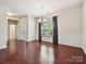Inviting dining room featuring hardwood floors, wainscoting, large window, and chandelier at 5355 Hackberry Sw Ln, Concord, NC 28027