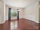 Elegant dining area with hardwood floors, wainscoting, and a chandelier at 5355 Hackberry Sw Ln, Concord, NC 28027