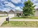 Beautiful single-story home with brick accents, attached garage, and a lush green lawn at 5355 Hackberry Sw Ln, Concord, NC 28027