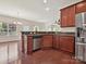 Spacious kitchen with stainless steel appliances and adjacent dining area, featuring hardwood floors at 5355 Hackberry Sw Ln, Concord, NC 28027