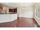 Bright and open kitchen with cherry wood cabinets, stainless appliances, and hardwood floors at 5355 Hackberry Sw Ln, Concord, NC 28027