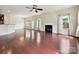 Open living room with fireplace, ceiling fan, and dining area at 5355 Hackberry Sw Ln, Concord, NC 28027