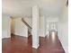 Spacious open-concept living area with hardwood floors and a staircase at 5355 Hackberry Sw Ln, Concord, NC 28027
