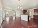 Open living area featuring hardwood floors flowing into the kitchen at 5355 Hackberry Sw Ln, Concord, NC 28027