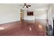 Open concept living room and kitchen with hardwood floors and modern lighting at 5355 Hackberry Sw Ln, Concord, NC 28027