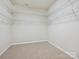 Spacious walk-in closet equipped with built-in shelving for optimal storage solutions at 5355 Hackberry Sw Ln, Concord, NC 28027