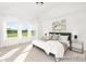 Bedroom with large windows, plush bedding, and stylish decor for a comfortable retreat at 5594-C Galloway Dr # 99P, Stanfield, NC 28163