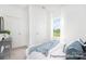 Bright bedroom with white walls, plush carpeting, and view to exterior at 5594-C Galloway Dr # 99P, Stanfield, NC 28163