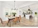 Open-concept dining area with elegant decor, seamlessly connecting to a modern kitchen with a central island at 5594-C Galloway Dr # 99P, Stanfield, NC 28163