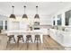 Bright, modern kitchen features a large center island, stainless appliances, and elegant pendant lighting fixtures at 5594-C Galloway Dr # 99P, Stanfield, NC 28163