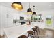 Bright, modern kitchen features a large center island, stainless appliances, and elegant pendant lighting fixtures at 5594-C Galloway Dr # 99P, Stanfield, NC 28163