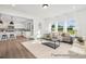 Spacious living room featuring an open layout, stylish furnishings, large windows, and seamless flow to the kitchen at 5594-C Galloway Dr # 99P, Stanfield, NC 28163