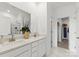 Bright bathroom with dual sinks, granite countertop, and a glass-enclosed shower and walk-in closet at 566 Mountain View Dr, Monroe, NC 28110
