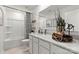 Clean, bright bathroom featuring a modern vanity with a large mirror and a shower with a striped curtain at 566 Mountain View Dr, Monroe, NC 28110