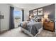Inviting bedroom showcasing sports themed decor, a comfortable bed, and a view from the bright window at 566 Mountain View Dr, Monroe, NC 28110