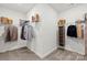 Organized walk-in closet with shelving, hanging rods, and ample space for clothing and accessories at 566 Mountain View Dr, Monroe, NC 28110