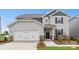 Charming two-story home with gray siding, stone accents, and a two-car garage at 566 Mountain View Dr, Monroe, NC 28110