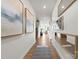 Bright hallway with hardwood floors, elegant mirrors, and artwork leading to the living room at 566 Mountain View Dr, Monroe, NC 28110