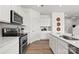 Well-equipped kitchen featuring modern appliances, white cabinetry, and a functional layout at 566 Mountain View Dr, Monroe, NC 28110