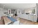 Spacious living room and dining area with hardwood floors, modern lighting, and a cozy fireplace at 566 Mountain View Dr, Monroe, NC 28110