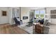 Bright living room featuring stylish furnishings, large windows offering a view, and a modern fireplace at 566 Mountain View Dr, Monroe, NC 28110