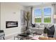 Bright living room with a modern fireplace, large windows offering scenic views, and comfortable seating at 566 Mountain View Dr, Monroe, NC 28110