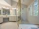 Bright bathroom with white vanity and a glass shower enclosure at 5917 Summerston Pl, Charlotte, NC 28277