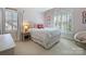 A cozy bedroom with carpet, a shuttered window, and natural light at 5917 Summerston Pl, Charlotte, NC 28277