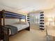 A spacious bedroom with carpet, a bunk bed, and natural light at 5917 Summerston Pl, Charlotte, NC 28277
