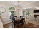 Bright dining room features a round table with four chairs and a window offering backyard views at 5917 Summerston Pl, Charlotte, NC 28277