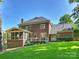 Charming brick home with screened porch, deck, lush lawn, and manicured landscaping at 5917 Summerston Pl, Charlotte, NC 28277