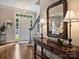 Inviting foyer features hardwood floors, an entry door with sidelights, and elegant decor at 5917 Summerston Pl, Charlotte, NC 28277