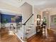 Elegant foyer featuring hardwood floors, staircase, and views into the dining room, exuding classic style at 5917 Summerston Pl, Charlotte, NC 28277