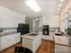 Spacious kitchen features an island cooktop, granite countertops, black appliances, and white cabinets at 5917 Summerston Pl, Charlotte, NC 28277