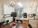 Bright kitchen with a central island, black appliances, and white cabinetry with hardwood floors at 5917 Summerston Pl, Charlotte, NC 28277