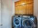 Convenient laundry room features a side-by-side washer and dryer unit at 5917 Summerston Pl, Charlotte, NC 28277