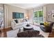 Inviting living room with large windows, neutral decor, and modern furnishings, perfect for relaxation at 5917 Summerston Pl, Charlotte, NC 28277