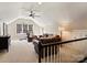 Cozy bonus room with a ceiling fan, comfortable leather seating, and a sunny window at 5917 Summerston Pl, Charlotte, NC 28277