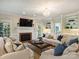 Spacious living room with fireplace, built-in bookshelves, and large windows for natural light at 5917 Summerston Pl, Charlotte, NC 28277