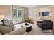 Bright living room with large windows and stylish decor, hardwood floors, and neutral color palette at 5917 Summerston Pl, Charlotte, NC 28277