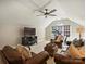Cozy bonus room with a ceiling fan, comfortable leather seating, and a sunny window at 5917 Summerston Pl, Charlotte, NC 28277