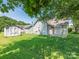 A spacious backyard with a shed and partial view of the home's exterior at 6212 Derryfield Dr, Charlotte, NC 28213