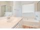 Clean bathroom featuring a soaking tub and a vanity with a sink at 6212 Derryfield Dr, Charlotte, NC 28213