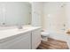 Clean bathroom with a white vanity, large mirror, and shower-tub combo at 6212 Derryfield Dr, Charlotte, NC 28213